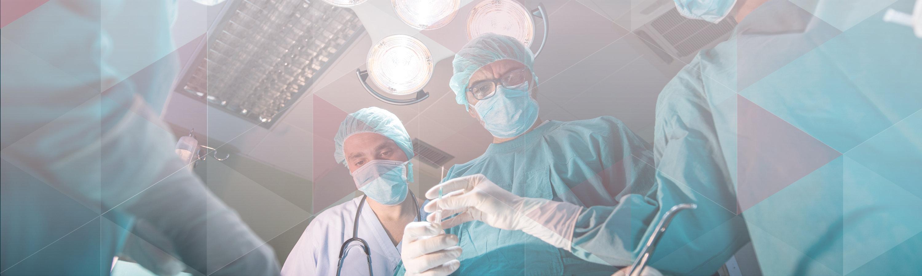 Doctors and nurses looking down on a patient in a surgical theatre