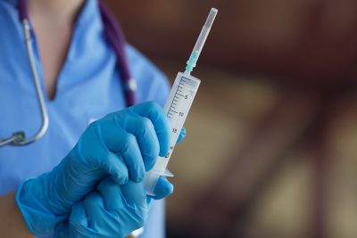 Medical professional holding a medical tube